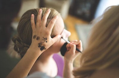 Makeup artist working on model