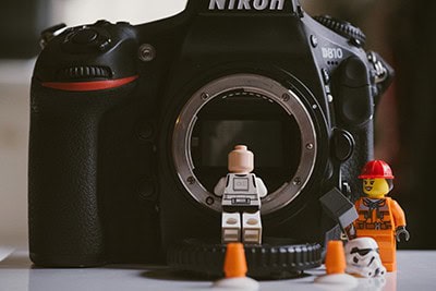 Lego figures inspecting inside of DSLR camera