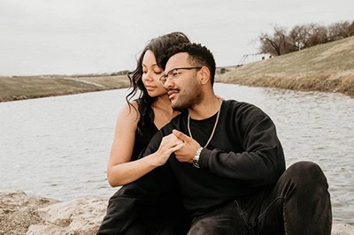 Black couple holding hands by lake