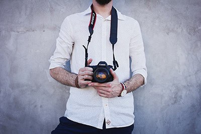 Male photographer against wall