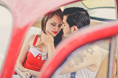 Young white couple in car about to kiss