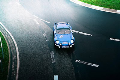 Blue sports car on black road