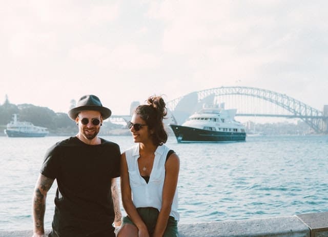 Young couple holding hands near waterway