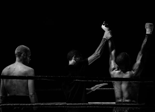 Black and white image of winning boxer