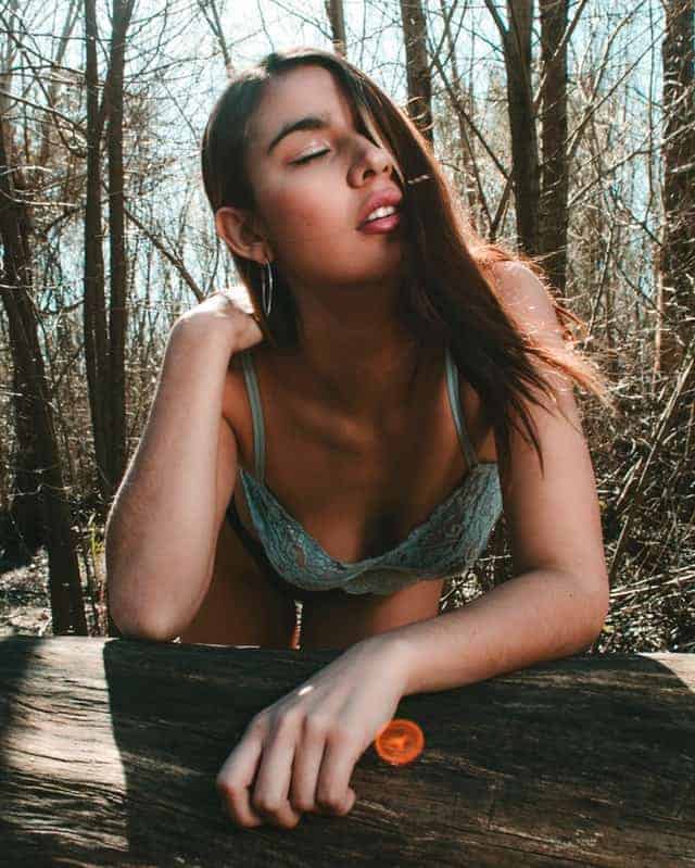 Young girl in woods in teal laced bra